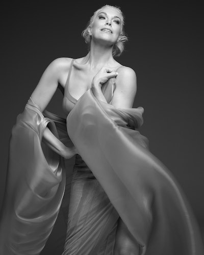 Hannah Waddingham is wearing a Kathryn Bowen dress with a Maison Met cape for a photoshoot.