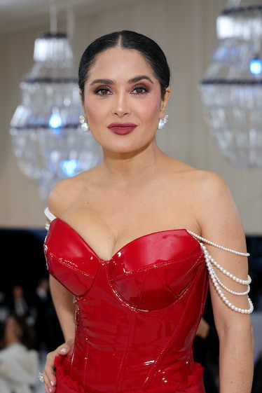 Salma Hayek with a berry lip and sleek ponytail at the 2023 met gala
